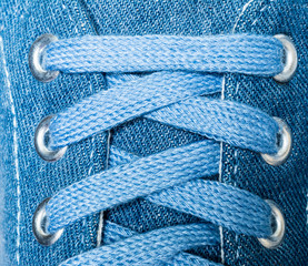 Denim sneakers close-up macro texture isolated on white background