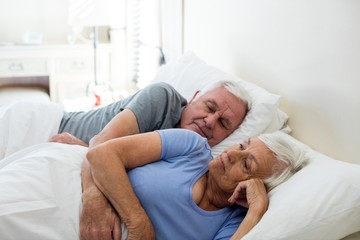 Senior couple sleeping in the bedroom