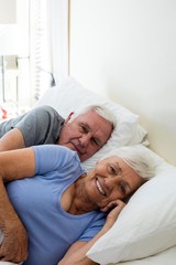 Senior couple relaxing in the bedroom
