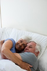 Senior couple embracing each other in the bedroom