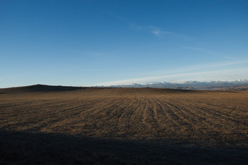 field at dawn, the Caucasus , sky blue.