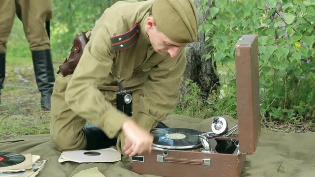 The army of the USSR. Soviet army soldiers are resting. Soldiers listen to a gramophone. Soviet Union soldiers in camp. Reconstruction of the Soviet army.