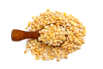 Dried yellow peas in wooden spoon isolated on white background. Top view