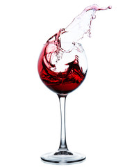 Red wine splashing in a glass