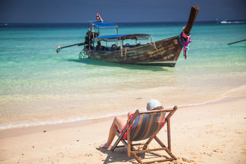 KO PHI PHI, THAILAND, February 2, 2014: Tropical beach with traditional long tail boats on the beach Mosquito island, Ko Phi Phi archiplago, Andaman Sea, famous tourist destination in Thailand