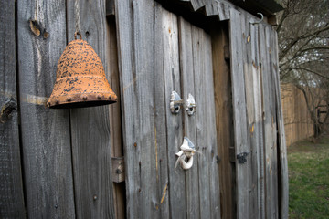 Vintage decorations hanging on side of old wooden shed