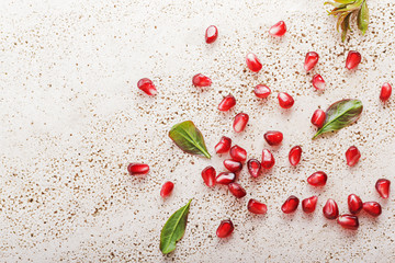 Ripe pomegranate seeds on marble 
vintage background