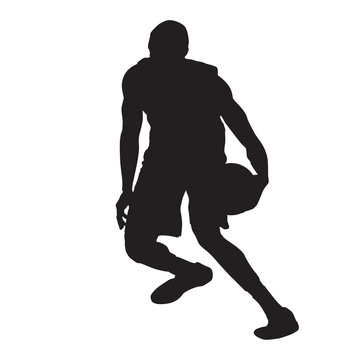 Basketball player crossover dribbling, vector silhouette