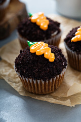 Carrot cupcakes with chocolate crumbs and frosting