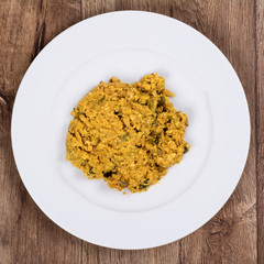 Vegetarian food on a plate with wooden background