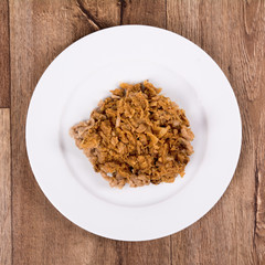 Vegetarian food on a plate with wooden background