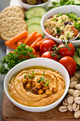 Hummus and vegetables platter with grain salad