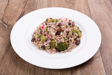 Vegetarian food on a plate with wooden background