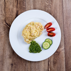 Vegetarian food on a plate with wooden background