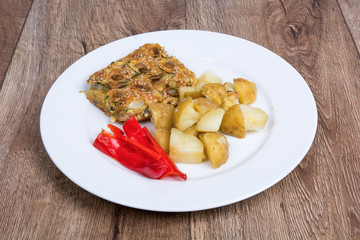Vegetarian food on a plate with wooden background