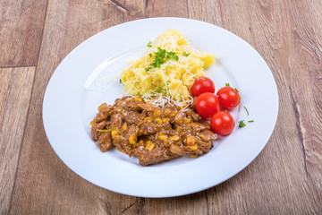 Vegetarian food on a plate with wooden background
