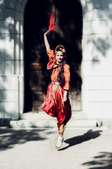 beautiful girl in traditional Turkish costume plays and jumps with a scarf