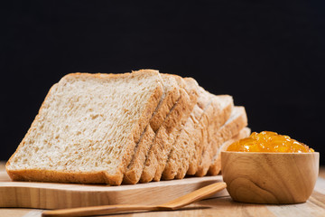 slices bread with jam on wooden table
