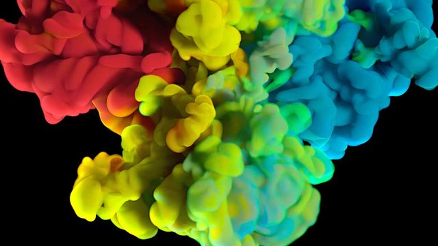 Colorful rainbow paint drops from above mixing in water. Ink swirling underwater. Cloud of silky ink isolated on black background. Colored abstract smoke explosion animation effect. Close up view.