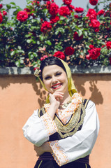portrait of happy young peasant woman in national costume
