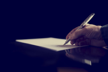 Businessman signing a document or taking notes