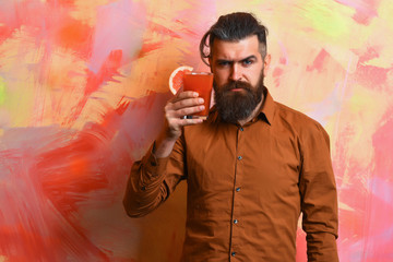 Brutal caucasian hipster holding tropical alcoholic fresh cocktail