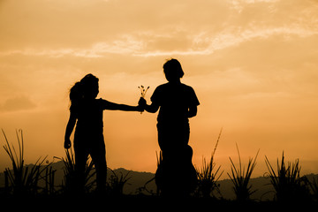Fototapeta na wymiar happy couple playing at summer sunset in nature