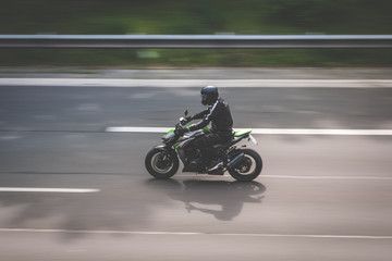 Obraz na płótnie Canvas motorbike driving on highway , motion blur