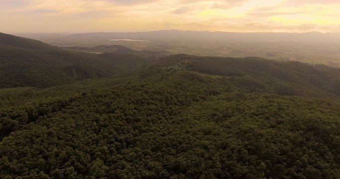 Aerial footage, beautiful green landscape with wood on the hills in Tuscany, Italy, 4K