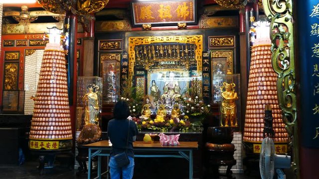 Woman praying inside Hsinchu Cheng Huang temple