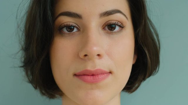 Very close up woman portrait. Attractive woman looking at the camera and smiling. Close up