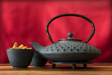 Cast iron Asian teapot with herbal tea 