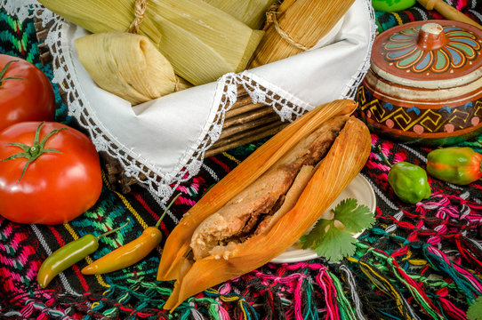 Tamal rojo, Mexican dish made with corn dough, chicken or pork and chili, wrapped in a corn leaves.