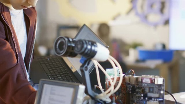 Boy Works on a Fully Functional Programable Robot with Bright LED Lights for His School Robotics Club Project. Shot on RED EPIC-W 8K Helium Cinema Camera.