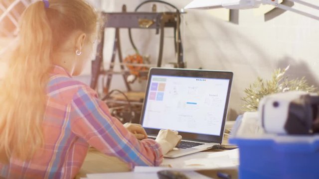 Smart Girl Work on a Laptop For Her Science Class School Project. Shot on RED EPIC-W 8K Helium Cinema Camera.