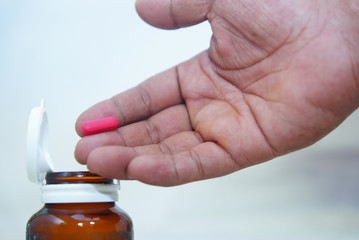 hand holding medicine capsule