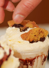 Close up of a cheff preparing a milkshake on top a pieces of cookies