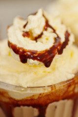 Close up of a milkshake with chocolate syrup and cream on top