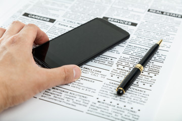 fake newspaper and smartphone