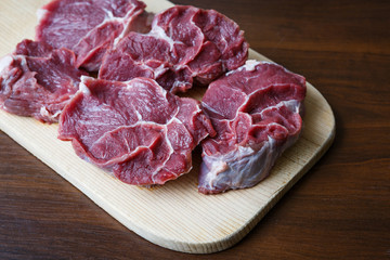 Fresh raw beef on wooden cutting plate