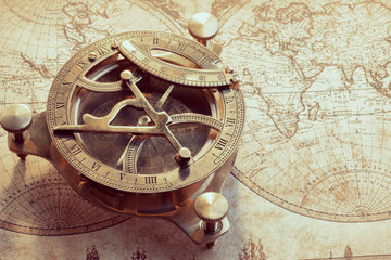 Fototapeta na wymiar Old compass over ancient map