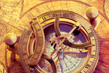 Old compass over ancient map