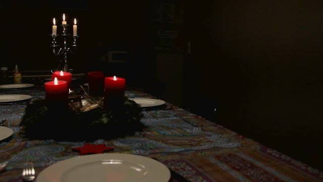 Christmas Decaration With a Silver Candlestick and Red Decorative Candles on a Holiday Table