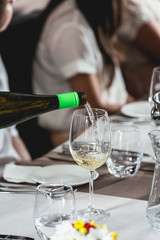 sommelier pouring wine into glass at wine and food tasting