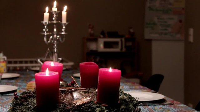Christmas Decaration With a Silver Candlestick and Red Decorative Candles on a Holiday Table