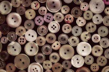 Old buttons on black background