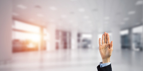 Choosing gesture of businessperson in elegant modern interior in sunshine light