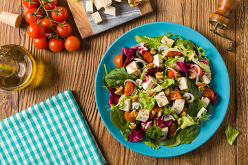 Delicious salad with tofu, tomatoes and walnuts.