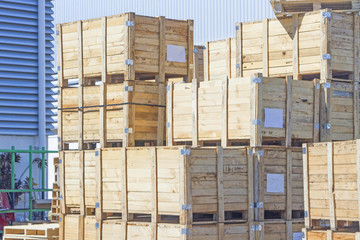 The stack of wooden crates next to the factory.