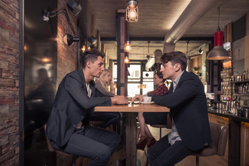 four people talking, small group of people talking, coffee shop indoors